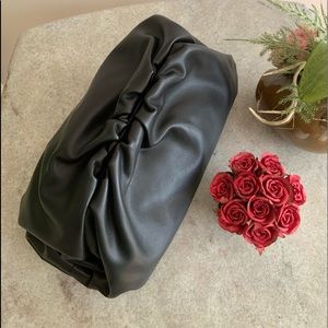 Similar to the Bottega Veneta ‘The Pouch’ purse.